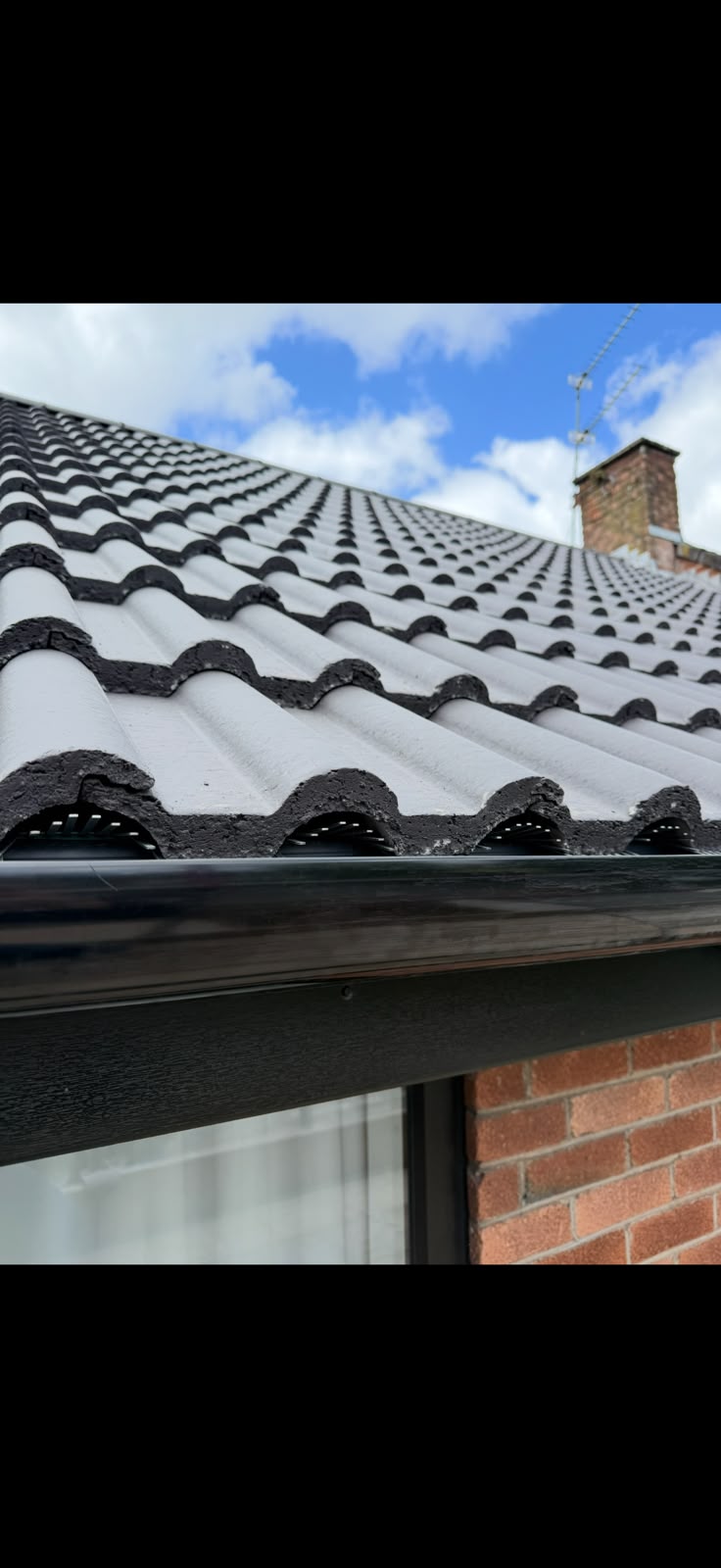 Roof tiles and gutter detail from TJS Roofing Solutions